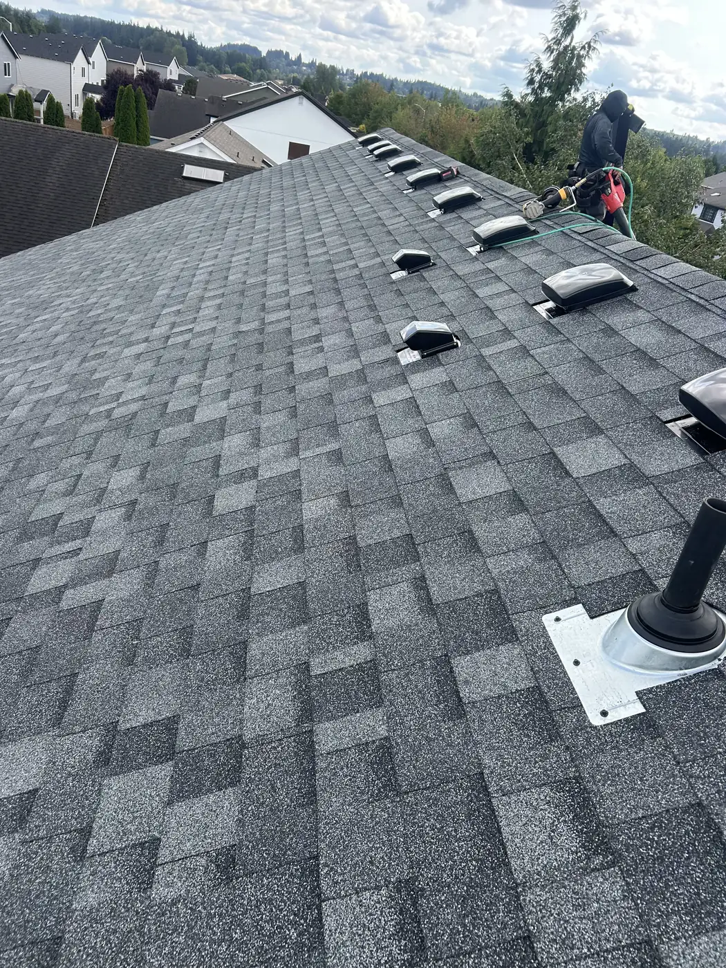Roofer installing ridge vents during a full roof replacement, Chehalis WA