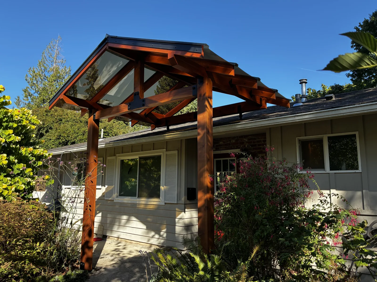 Full view of a completed stained timber gabled entryway structure attached to a home, Clark County WA