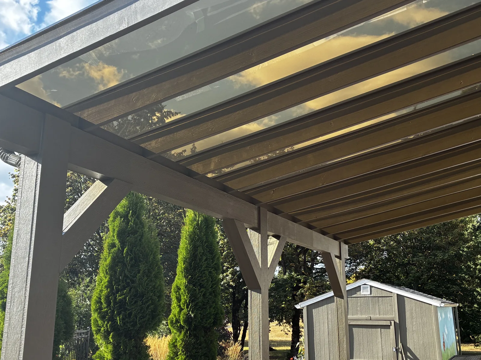 Underside detail of a completed EZ-Glaze carport showing timber frame and gutter, Clark County WA