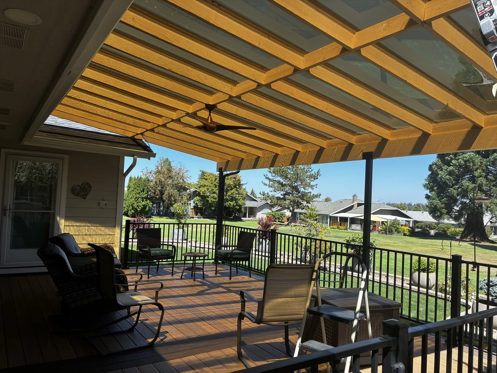 Completed Signature-tier covered patio with stained Doug Fir timber frame and EZ-Glaze polycarbonate roof, Clark County WA